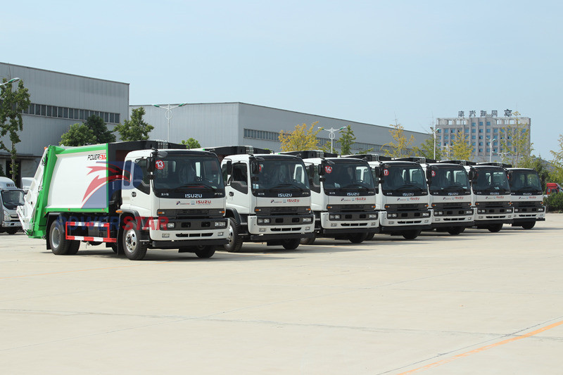 Mongolia - Isuzu FVR garbage truck at NPR boom crane truck
    